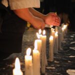 person holding candles with fire